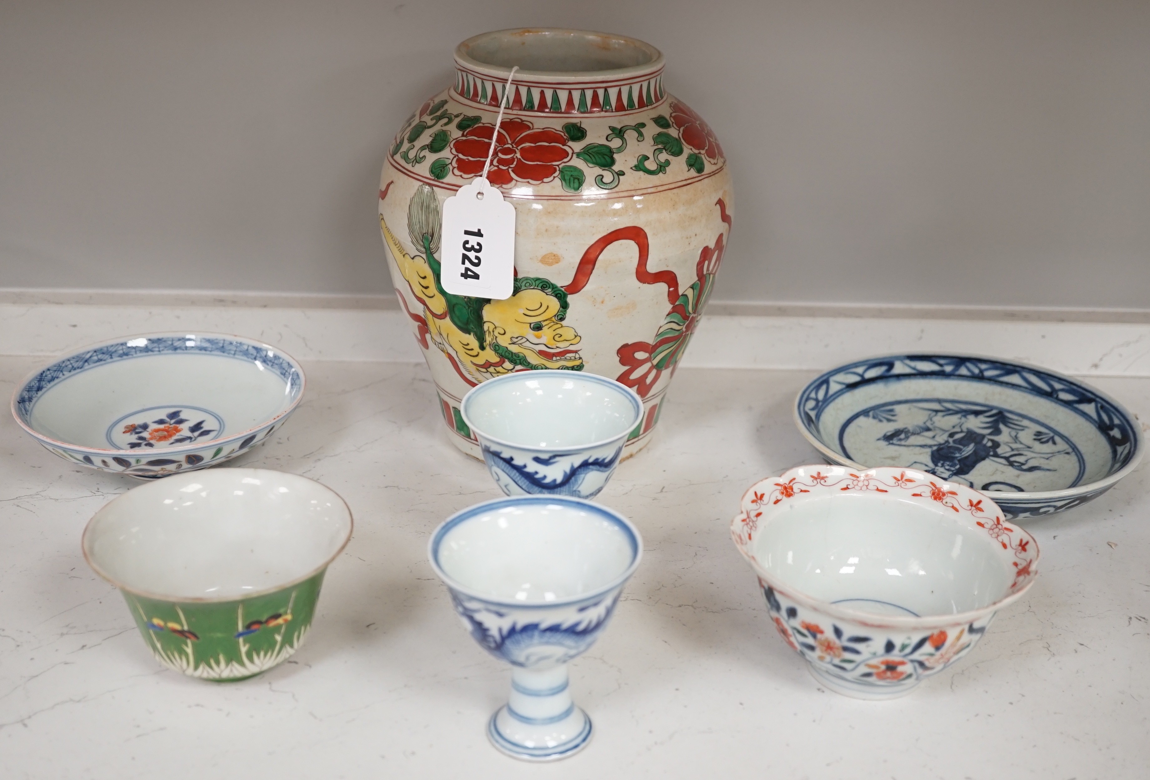A Chinese wucai vase, two Imari bowls, a pair of Chinese blue and white dragon stem cups, Xuande marks, a Chinese blue and white dish, depicting a scholar on horseback, Xuande mark, a small green Chinese bowl, painted wi
